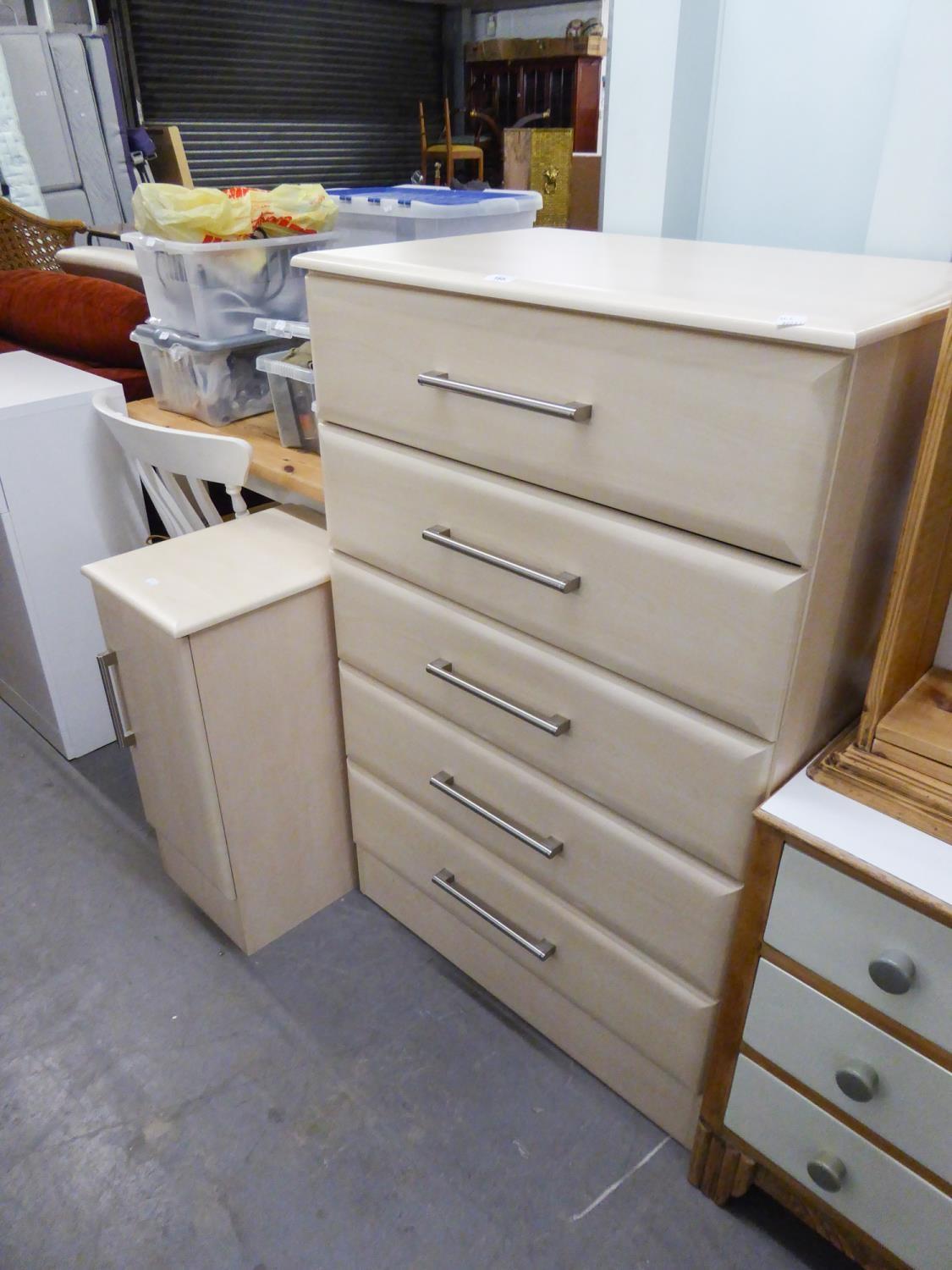 A PINK WOOD EFFECT CHEST OF FIVE LONG DRAWERS AND A MATCHING BEDSIDE CUPBOARD