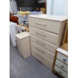 A PINK WOOD EFFECT CHEST OF FIVE LONG DRAWERS AND A MATCHING BEDSIDE CUPBOARD