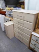 A PINK WOOD EFFECT CHEST OF FIVE LONG DRAWERS AND A MATCHING BEDSIDE CUPBOARD