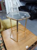 A BRASS FRAMED HEXAGONAL COFFEE TABLE WITH INSET GLASS TOP, THREE STRAIGHT LEGS SUPPORT ON THE FLOOR