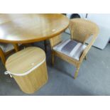 A CANE TUB ARMCHAIR AND A SLATTED WOOD OVAL LINEN RECIEVER