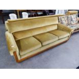 A LOUNGE SUITE OF THREE PIECES WITH OAK FRAME AND SHOW WOOD FRONTS, COVERED IN GOLD VELVET, VIZ A