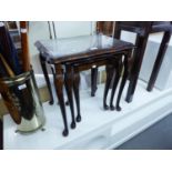 A NEST OF THREE MAHOGANY COFFEE TABLES WITH PLATE GLASS PROTECTORS AND A MAHOGANY TELEVISION STAND