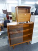 A TEAK EFFECT BOOKCASE WITH TWO GLASS SLIDING DOORS AND A TEAK MAGAZINE RACK/COPFFEE TABLE (2)
