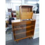 A TEAK EFFECT BOOKCASE WITH TWO GLASS SLIDING DOORS AND A TEAK MAGAZINE RACK/COPFFEE TABLE (2)