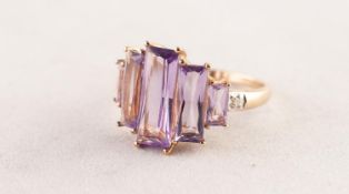 9ct GOLD DRESS RING set with five emerald cut amethysts graduating from the centre, a tiny diamond