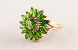 9ct GOLD OVAL FLORAL CLUSTER RING set with centre oval olivine, surround of eight tiny diamonds