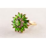 9ct GOLD OVAL FLORAL CLUSTER RING set with centre oval olivine, surround of eight tiny diamonds