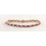 9ct GOLD, RUBY AND DIAMOND BRACELET, with 18 yellow and white gold 'X' shaped links each set with