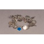 SILVER CURB PATTERN BRACELET, with swivel clip clasp and approximately 20 SILVER AND METAL CHARMS