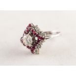 WHITE GOLD, DIAMOND AND RUBY SQUARE CLUSTER RING with a raised centre diamond claw set,