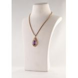 9ct GOLD TEAR SHAPED OPENWORK PENDANT, set with a large oval amethyst, 1 1/2in (3.75cm) high, 7.4