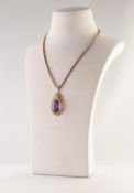 9ct GOLD TEAR SHAPED OPENWORK PENDANT, set with a large oval amethyst, 1 1/2in (3.75cm) high, 7.4