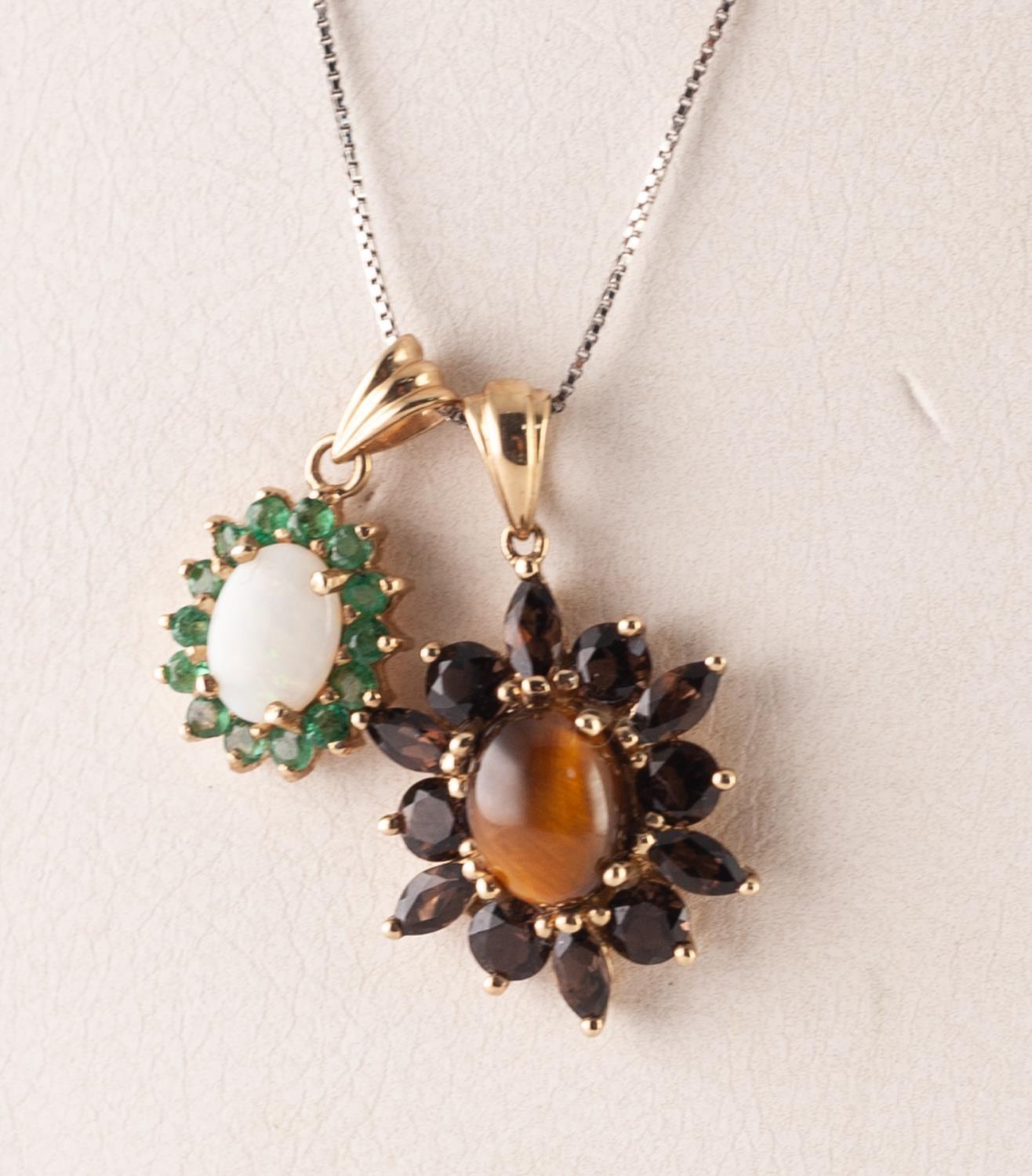 9ct GOLD, TIGER'S EYE AND GARNET OVAL PENDANT set with a cabochon tiger's eye and surround of twelve - Image 2 of 2