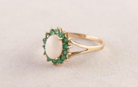 9ct GOLD, OPAL AND EMERALD OVAL CLUSTER RING set with a centre oval opal and surround of fourteen