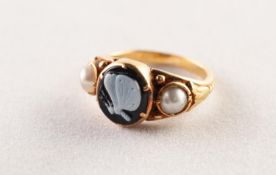 VICTORIAN GOLD MOURNING RING, the centre set with an oval onyx carved with a white butterfly on