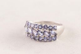 9ct WHITE GOLD RING with a row of six diagonally set lozenge shaped amethysts between two rows