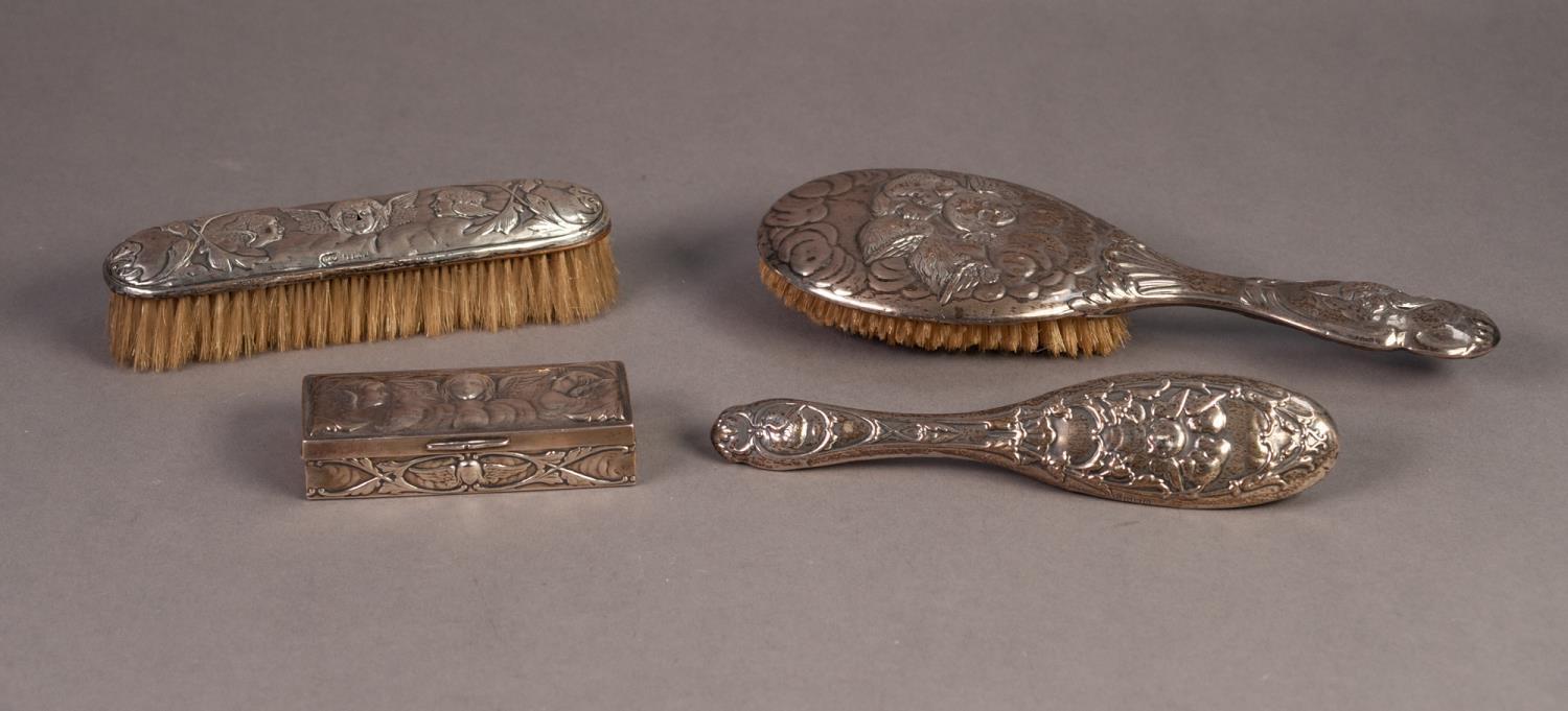 EDWARDIAN SILVER PIN BOX, the hinged lid and all sides repousse with winged cherubs, 4in (10.1cm)