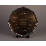 MODERN SILVER PRESENTATION SALVER, with gadrooned border to the wavy outline, raised on claw and