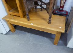 A LIGHT WOOD LARGE OBLONG COFFEE TABLE AND A TELEPHONE PEDESTAL WITH A SMALL DRAWER OVER AN OPEN