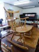 A LIGHTWOOD OPEN ARM ROCKING CHAIR, WITH STICK BACK AND SOLID WOODEN SEAT