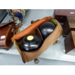 A PAIR OF LIGNUM VITAE LAWN BOWLS IN CANVAS CASE