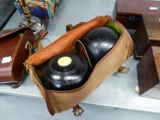 A PAIR OF LIGNUM VITAE LAWN BOWLS IN CANVAS CASE