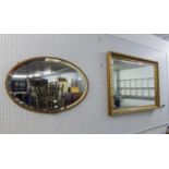 AN OBLONG BEVELLED EDGE WALL MIRROR, IN GILT FOLIATE SCROLL EMBOSSED FRAME, 3?4? WIDE AND AN OVAL