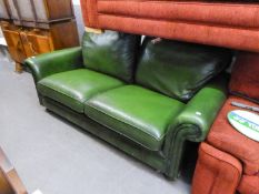 A FULLY UPHOLSTERED GREEN LEATHER THREE SEATER SETTEE (BY SPRINGVALE)