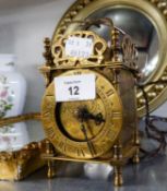 A VINTAGE BRASS SMALL LANTERN CLOCK WITH MAINS ELECTRIC MOVEMENT