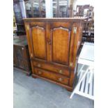 A TITCHMARSH AND GOODWIN DISTRESSED OAK TV. CABINET, HAVING TWO CUPBOARD DOORS OVER A DROP-FRONT