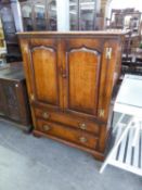 A TITCHMARSH AND GOODWIN DISTRESSED OAK TV. CABINET, HAVING TWO CUPBOARD DOORS OVER A DROP-FRONT