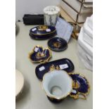 SEVEN PIECES OF LIMOGES, FRANCE PORCELAIN, EACH DECORATED IN GILT ON DARK BLUE WITH A LADY AND