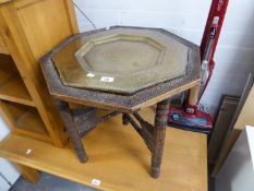 TWENTIETH CENTURY OCTAGONAL PERSIAN TABLE BRASS INSERT TO THE TOP WITH DECORATION, ON 'X' STAND WITH