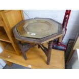 TWENTIETH CENTURY OCTAGONAL PERSIAN TABLE BRASS INSERT TO THE TOP WITH DECORATION, ON 'X' STAND WITH