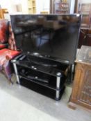 SANSUNG FLAT SCREEN TV. 41" WITH BLACK GLASS THREE TIER STAND AND TECHNIKA DVD PLAYER AND AN