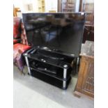 SANSUNG FLAT SCREEN TV. 41" WITH BLACK GLASS THREE TIER STAND AND TECHNIKA DVD PLAYER AND AN