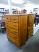 A CONTINENTAL POLISHED HARDWOOD TALL BOY CHEST OF FIVE LONG DRAWERS, ON HEAVY TURNED FEET AND A PAIR
