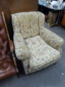 AN EDWARDIAN UPHOLSTERED ARMCHAIR