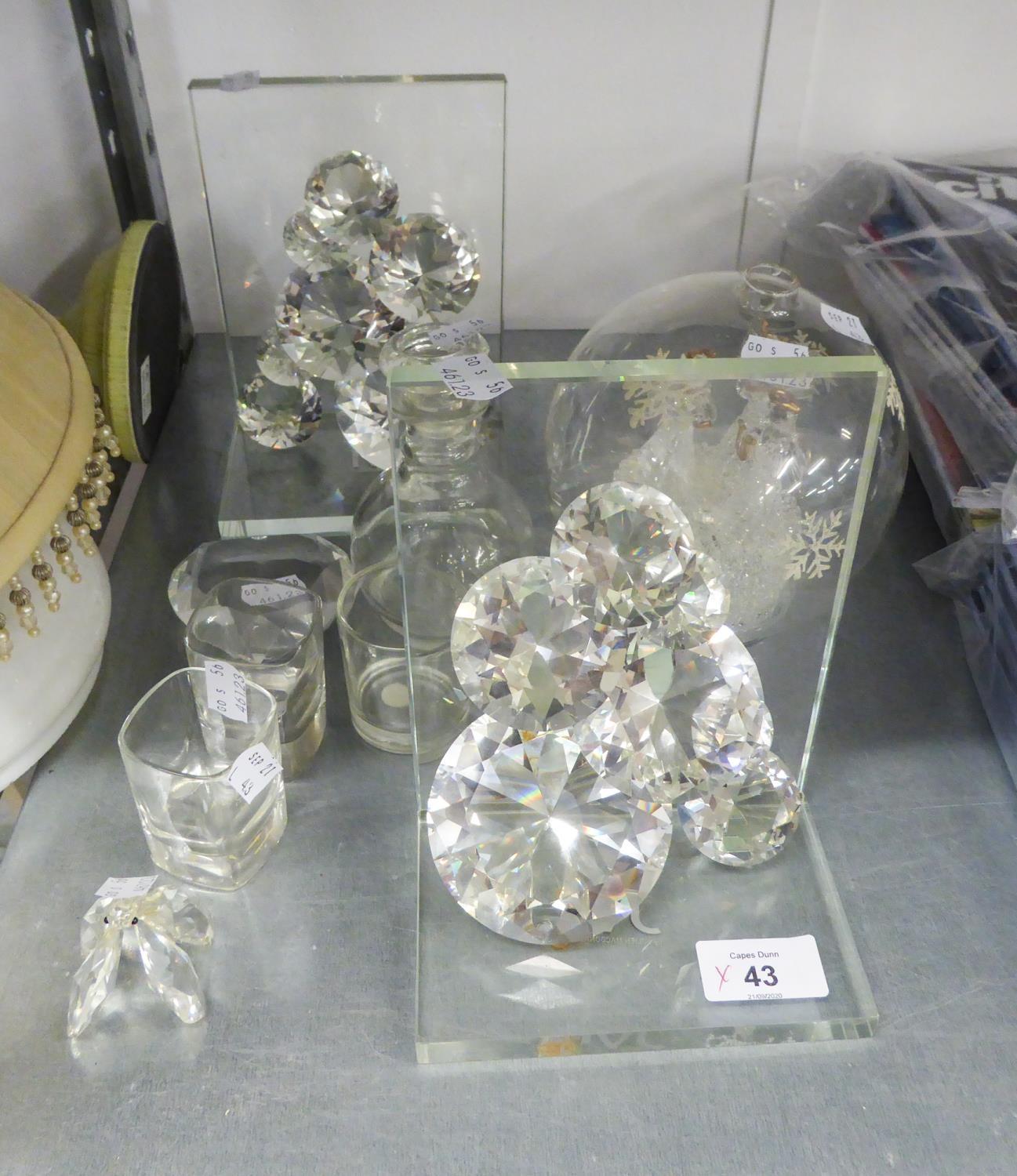 A PAIR OF JULIAN MACDONALD FACETED CUT GLASS BOOKENDS; A FACETED GLASS HEART SHAPED PAPERWEIGHT;