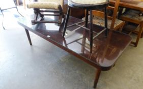 A LARGE OBLONG MAHOGANY COFFEE TABLE WITH QUADRANT CORNERS, ON POST SUPPORTS, 5? X 2?2? , WITH PLATE