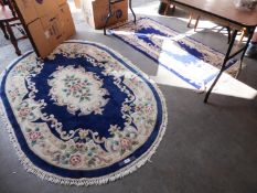 TWO CHINESE RUGS, ONE CIRCULAR AND ONE OBLONG, WITH ROYAL BLUE AND FLORAL PATTERN