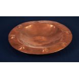 ARTS AND CRAFTS PLANISHED COPPER PLAQUE, of circular form with dished centre and raised, circular