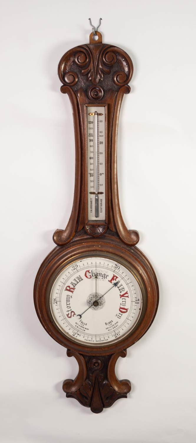 LATE VICTORIAN CARVED WALNUT ANEROID BAROMETER, the 8? dial set beneath a mercury thermometer to the