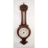 LATE VICTORIAN CARVED WALNUT ANEROID BAROMETER, the 8? dial set beneath a mercury thermometer to the