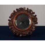 VICTORIAN CARVED OAK SMALL WALL MIRROR, the circular, bevel edged plate within a frame outlined with