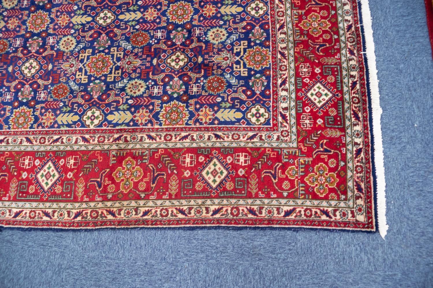 TABRIZ PERSIAN CARPET with all-over repeat formal floral, leaf and ram's horn patetrn on a dark blue - Image 2 of 3