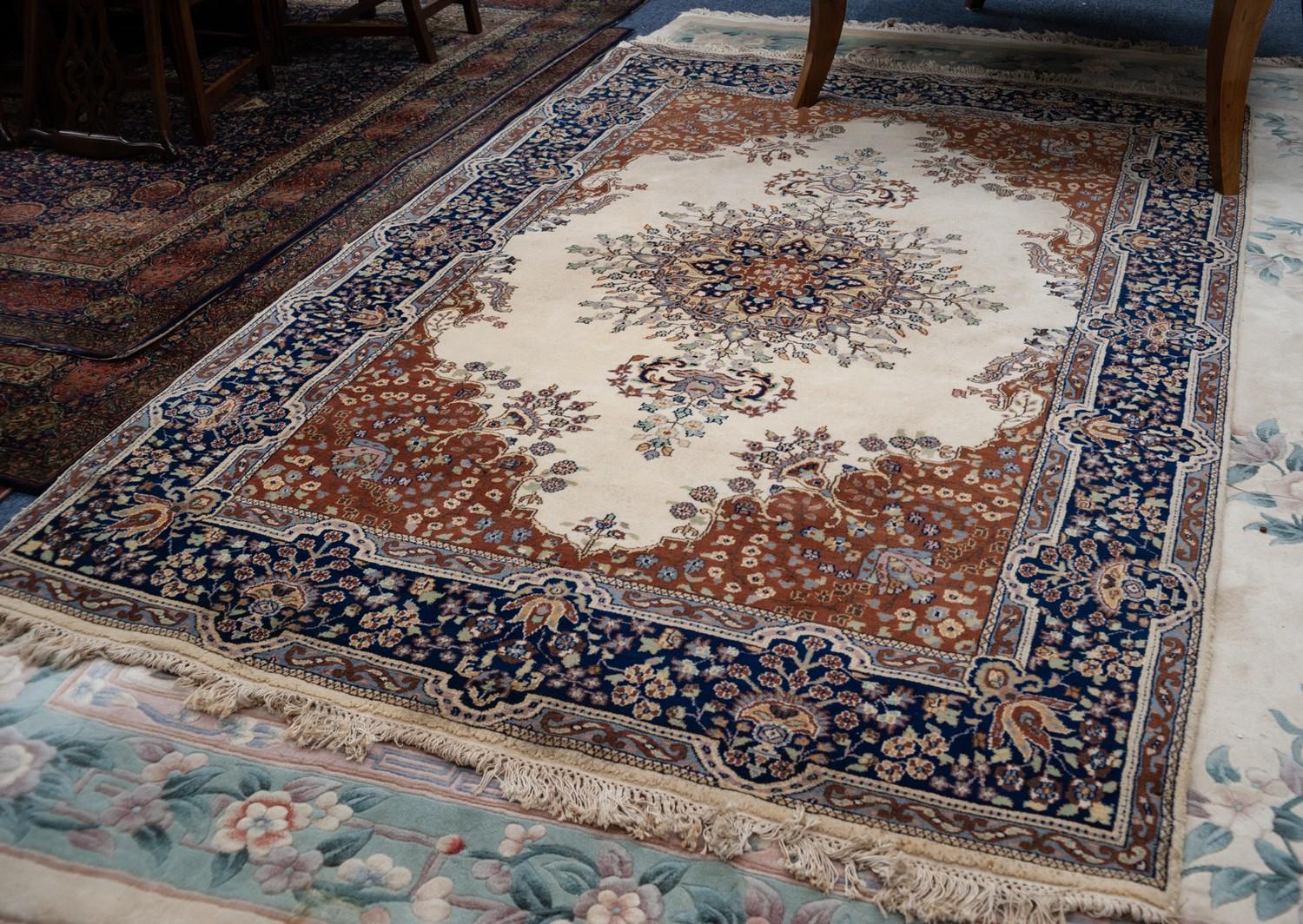 FINELY KNOTTED KIRMAN CARPET, the elaborated radiating floral circular centre medallion having