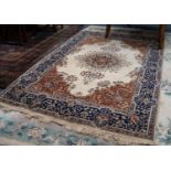 FINELY KNOTTED KIRMAN CARPET, the elaborated radiating floral circular centre medallion having