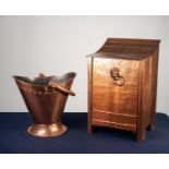 EARLY TWENTIETH CENTURY PLANISHED COPPER COAL PURDONIUM, with downswept top and captive lion mask